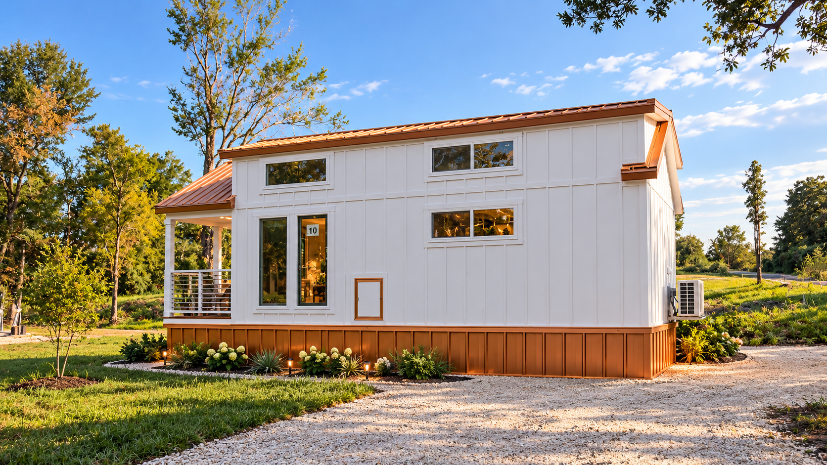 The Dawn tiny home with copper roof and landscaped grounds